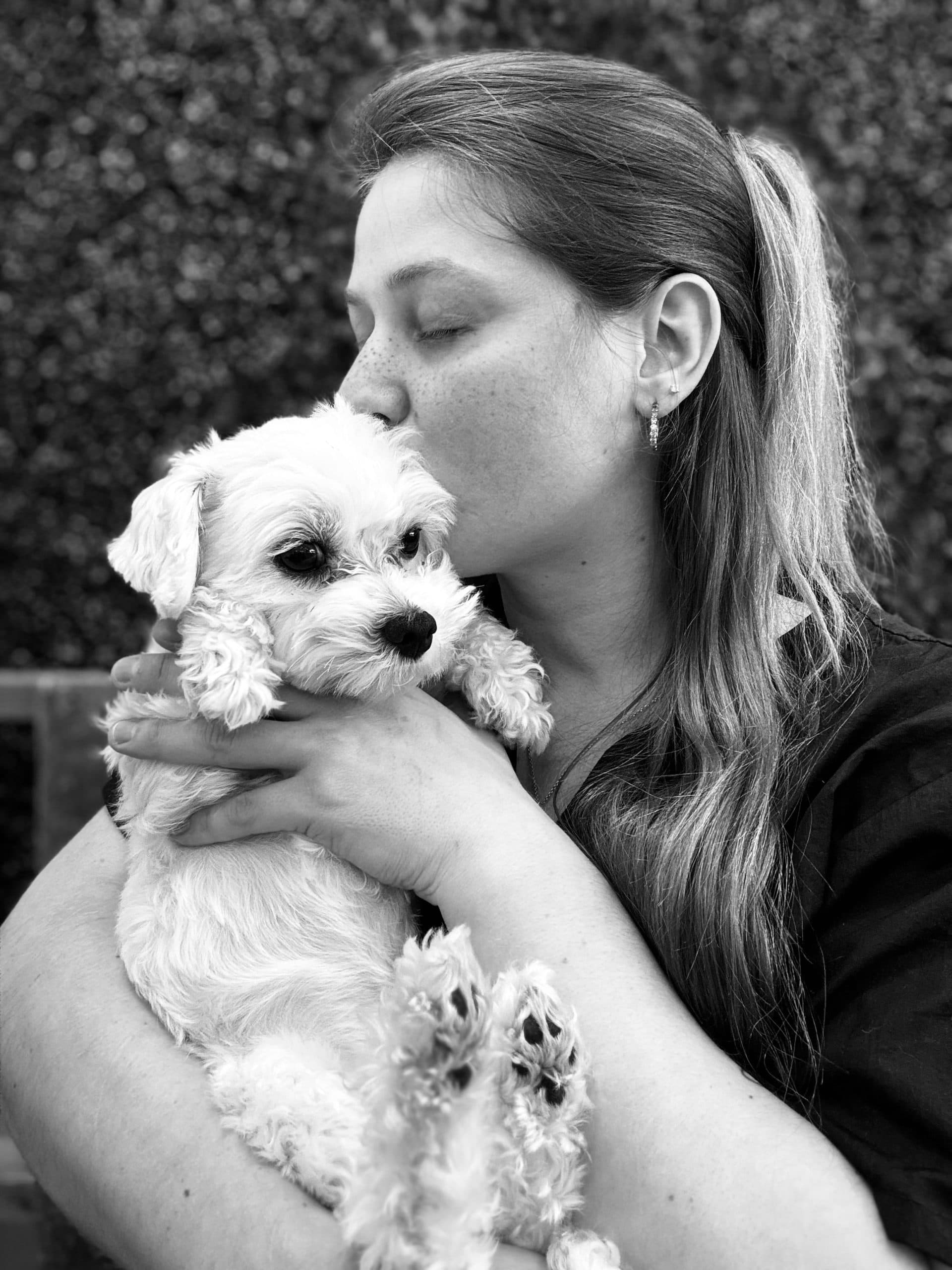 Sarah Clarke with a small white dog